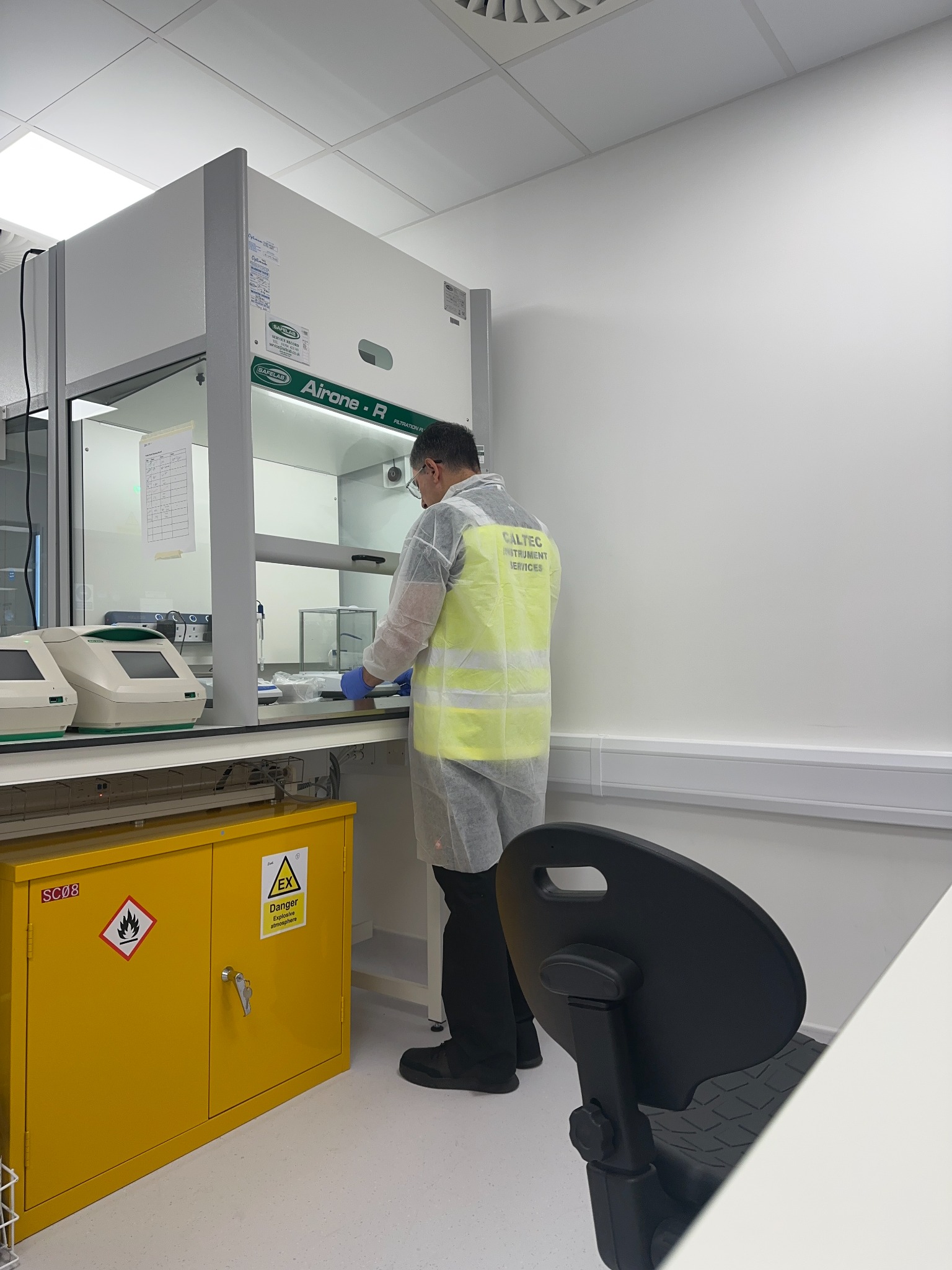 A Caltec engineer working with laboratory balances in a controlled laboratory environment